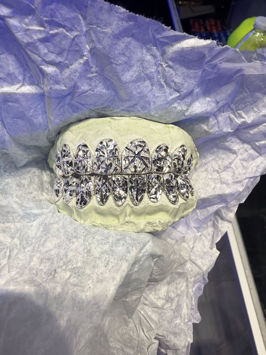 Silver grill with spider cuts on tissue paper